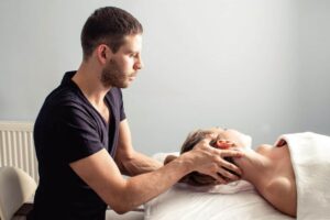 Physical Therapist massaging his customer