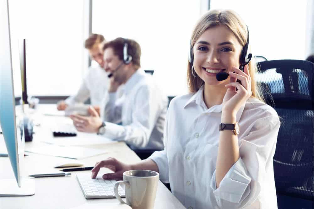 Female customer support operator with headset and smiling